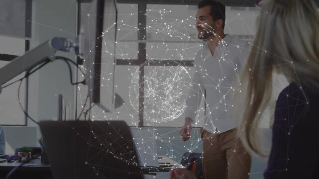 Man presenting biz screen to demo after laptop tap highfiving peer as network sphere overlaying man