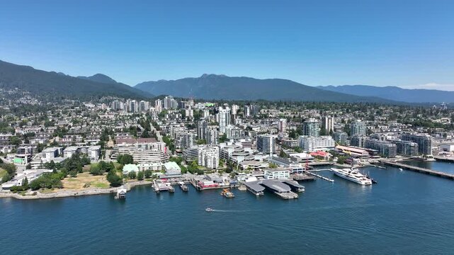 Drone Flying Toward North Vancouver Waterfront as Boat Travels Across Burrard Inlet