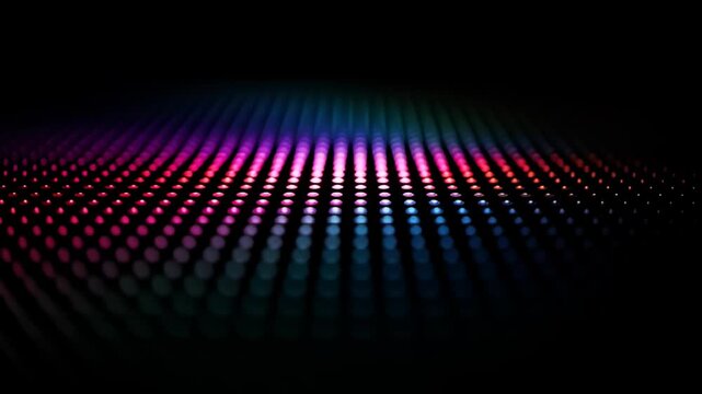 Array of rainbow-colored dots fade into the dark, creating soft, glowing pattern