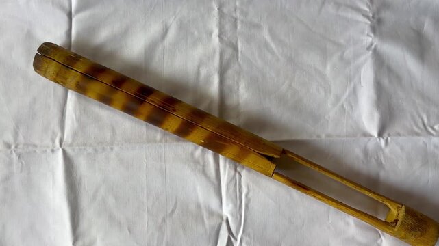 TOKA is a traditional bamboo percussion instrument from Assam, primarily used as a clapper to maintain rhythm in folk music. It is considered one of the essential instruments of the Bihu festivals