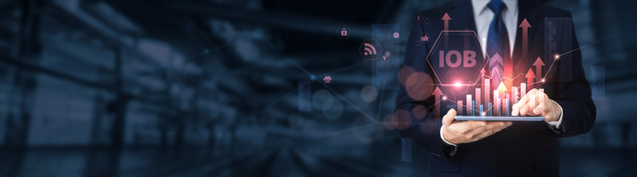 Businessman using a tablet for analyzing Internet of Behaviors (IoB) data and information, behavioral analytics, consumer insights, AI tracking, digital trends, smart technology.