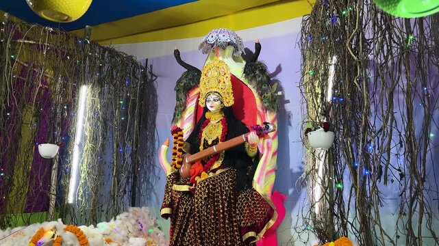 saraswati puja celebration with elaborately dressed goddess idol and festival organic decoration