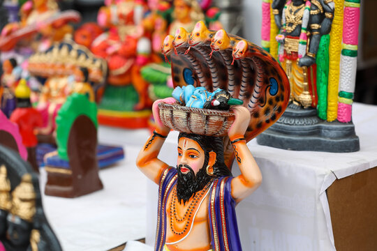 Vasudeva carrying baby krishna in a basket on his head idol displayed for sale in a shop for the golu festival	
