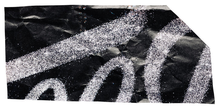 Crumpled piece of paper cut out for collage, wrinkled black scrap with sparkling silver pattern