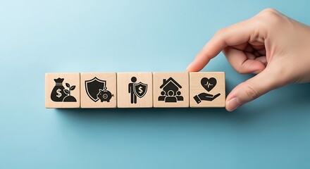 Hand placing wooden block with health icon on a row of blocks symbolizing financial security and protection