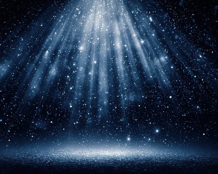 Foco de luz azul brilhante caindo sobre um palco escuro com part&iacute;culas cintilantes no ar.