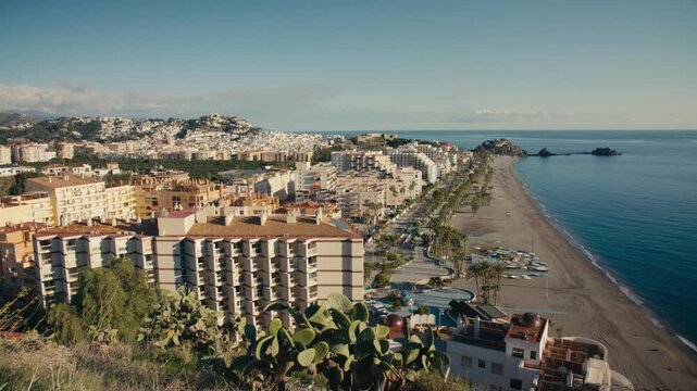 Timelapse of Almu&ntilde;&eacute;car beachfront and promenade along the Mediterranean coast in southern Spain during clear daylight.