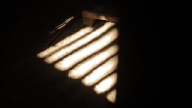 Reflection of sunlight from the ventilation that hits the dirt floor. Traditional vibe, rural atmosphere of Java Indonesia