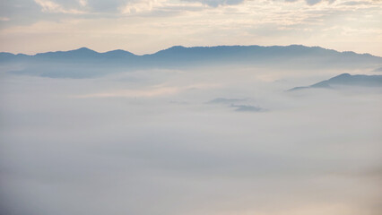 Obraz premium Aerial view of mountains and the sea of fog before sunrise by drone