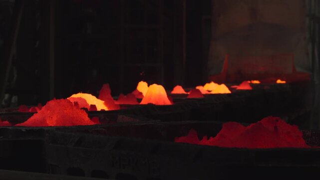 Glowing Molten Clusters. Soft Cooling Metallic Beads Shape Into Shining Hills In Factory Environment . Stock clip