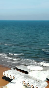 Abandoned lun class ekranoplan resting on sandy beach. Media