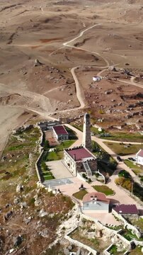 Aerial view of tillo castle and village in a mountainous landscape. Media