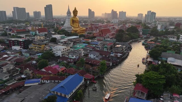 Golden buddha statue at wat paknam phasi charoen sunset sky with rivaer aerial view sightseeing travel in Bangkok Thailand 