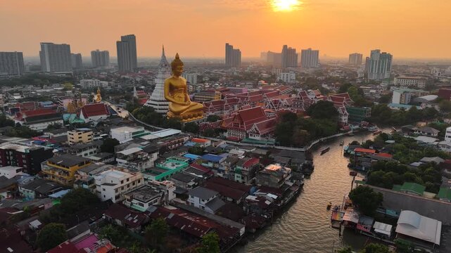 Golden buddha statue at wat paknam phasi charoen sunset sky with rivaer aerial view sightseeing travel in Bangkok Thailand 