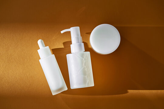 White cosmetic bottles and jar for skincare routine