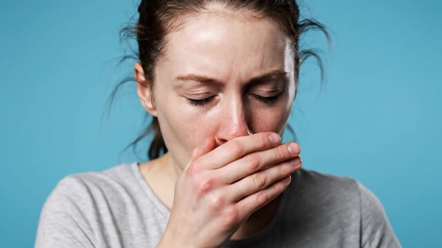 Ultra detailed realistic medium close up footage of person coughing covering mouth politely subtle expression of discomfort faint flushed nose natural chest and shoulder movement during breath clean s