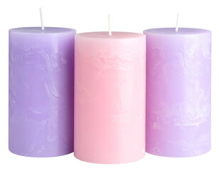 Three pillar candles in soft pastel shades lavender, pink, and lavender
