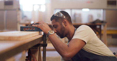 Carpenter, workshop and man with clamp on wood for furniture production, manufacturing or design....