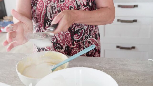 4K close-up video of dought being whisked in deep white bowl while making apple cake, homemade baking process, fresh ingredients, healthy food, nutritious dessert, cooking at home, nutrition concept