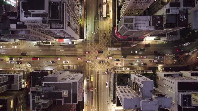 Night street intersection illumination in a rainy and cloudy famous Kowloon district cityscape aerial shot panorama 4k hong kong