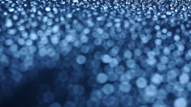 Many water droplets on hydrophobic black fabric, with good depth of field and blur