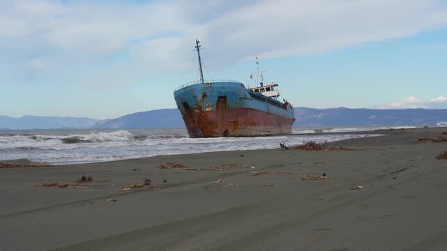 Abandoned Ship Aground on Sandy Beach as Metaphor for Financial Bankruptcy and Corporate Economic Slowdown