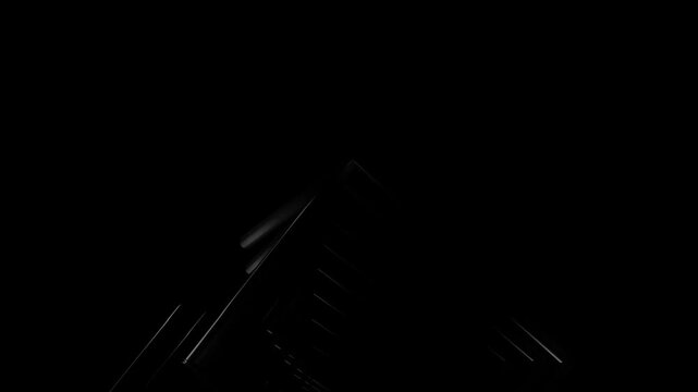 High contrast abstract structure composed of parallel linear elements emerging from darkness with subtle reflections creating modern technological atmosphere