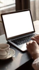 Fototapeta premium Person Typing on Laptop Next to Coffee
