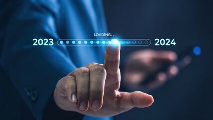 Businessman loading progress bar from 2023 to 2024 on virtual interface,new year transition and corporate planning concept,project timeline update and future strategy