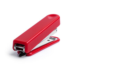 Red stapler on a white background. High quality photo