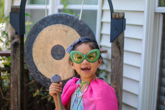 Confident young girl dressed as a super power princess