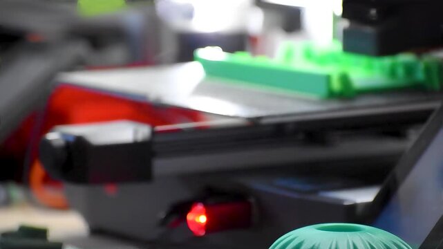 3d printer printing an object on the tray with filament