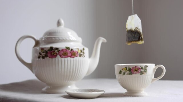 Video of a teabag being pulled out of antique cup.