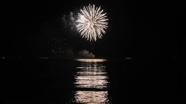 Fireworks Explode Over Water at Night.