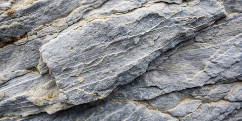 This rock formation displays various layers and textures typical of granite. The light reveals the details in the surface and patterns created by natural forces over time