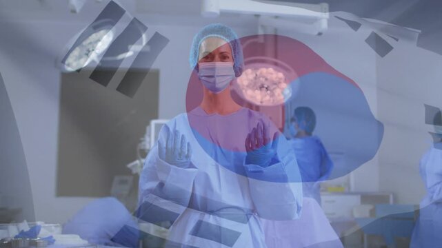 Lead surgeon raising hands Korean flag drifting over scene staff adjusting lamp preparing surgery