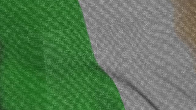 Camera sliding across woven green and gray cloth, revealing beige mark and changing folds for check
