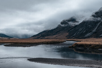 Mountains covered in mist above Lake Ōhau, South Island, New Zealand © ingetje