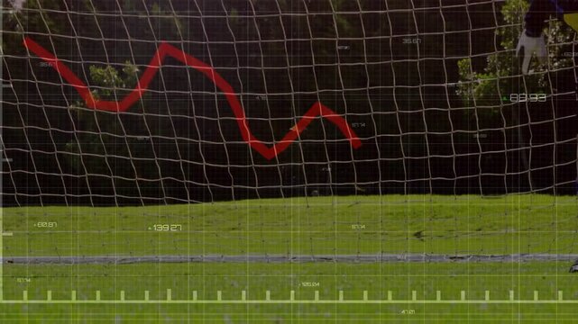 Soccer goalkeeper diving and securing ball after rolling shot, HUD grid and red analytics tracking