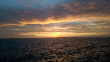 Obraz premium devastating and spectacular sea storm in Framura, Liguria, Cinque Terre - sea waves crash on the rocks of the coast creating an explosion of water - fiery sunset and white splashes of water