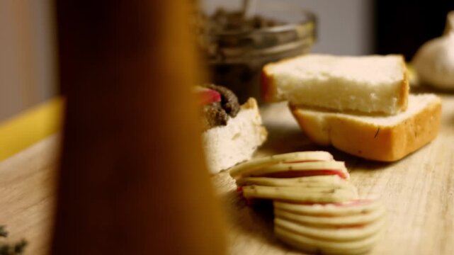 Open faced sandwich with mushroom pate on a slice of bread and radish presented on a wooden board