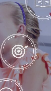 Vertical video: Girl hearing peer and turning while lens or chart icons floating over face for schoo