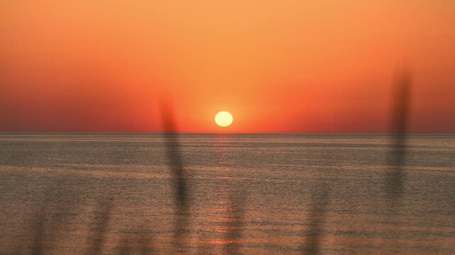 Tranquil baltic sea sunset with warm orange horizon and calm waters