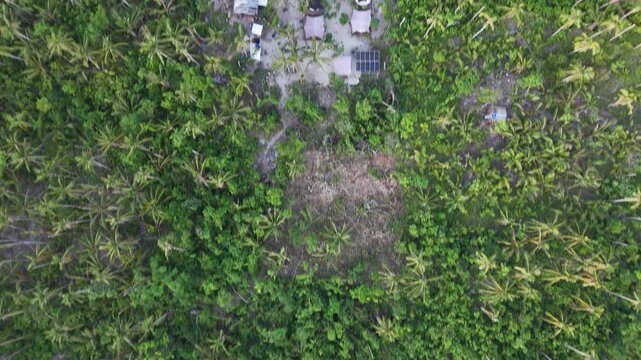 Drone aerial view of Bayang Basecamp or Calibangbangan Camp and turquoise reef along Calibangbangan Island coastline between Coron and El Nido, Palawan, Philippines.