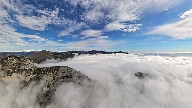 Aerial view above sea of clouds covering mountain valleys in the French Riviera hinterland
