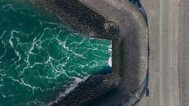 Aerial view of the meeting of the sea and land, with a road running alongside the coastline, Ouddorp, Zuid-Holland, Netherlands.