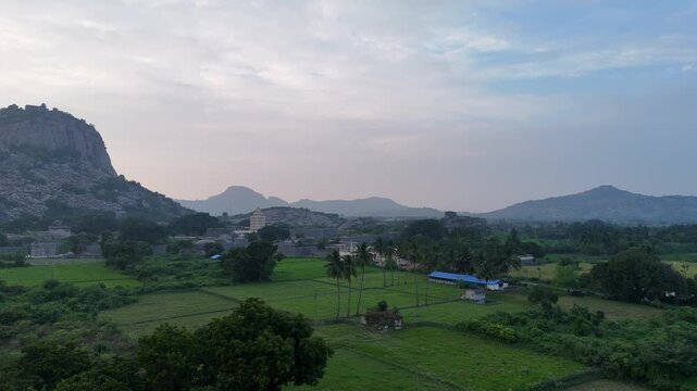 A beautiful drone view of Gingee Fort surrounded by rocky hills and greenery. The ancient walls and landscape highlight the historic beauty of this majestic fort from above.