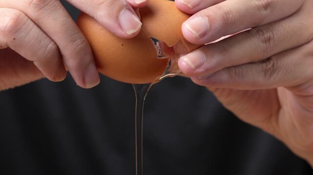 Macro shot of an eggshell cracking in a professional kitchen