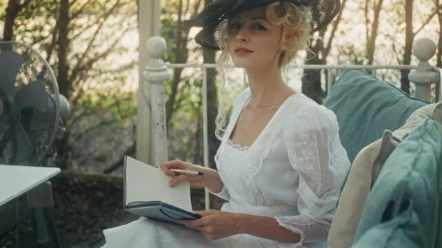 Woman Writing On Bench. Thoughtful Woman Documenting Memories On Outdoor Bench Surrounded By Lush Foliage
