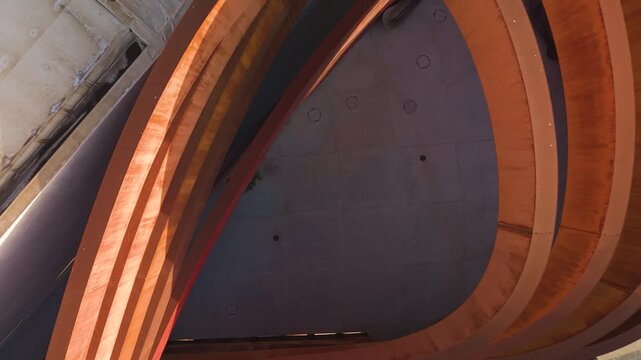 Mediatheque Design Museum's iconic red curves captured during a rising drone shot in Holon, Israel.